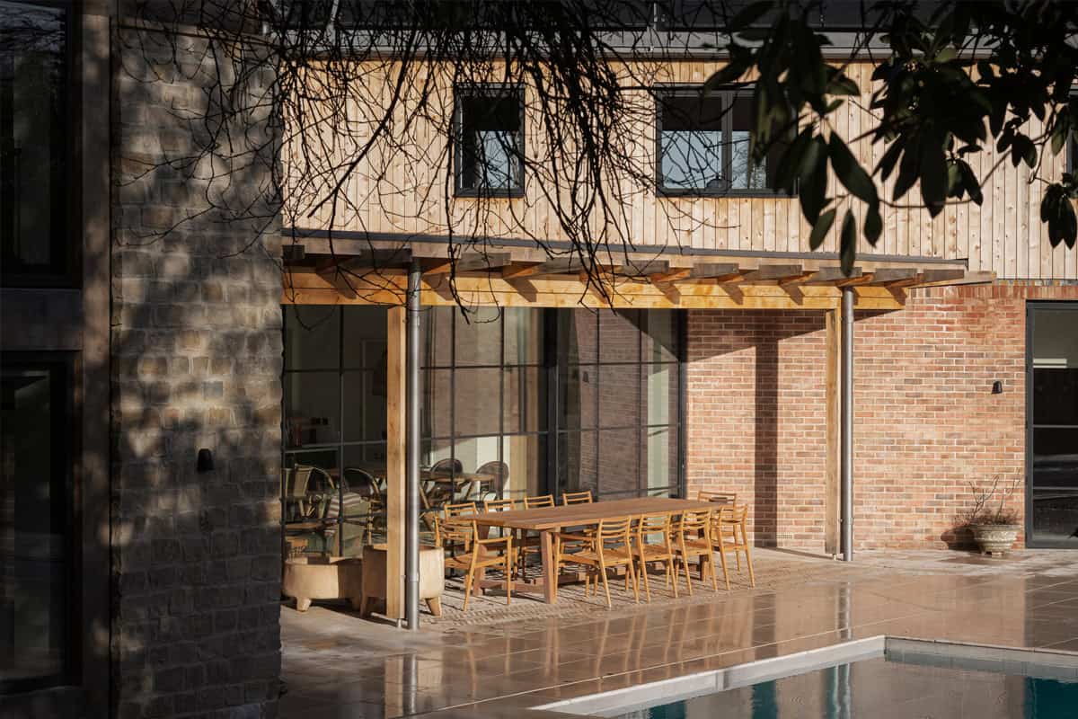 Hazelbridge Cottage timber treehouse with shingle cladding set among mature garden trees